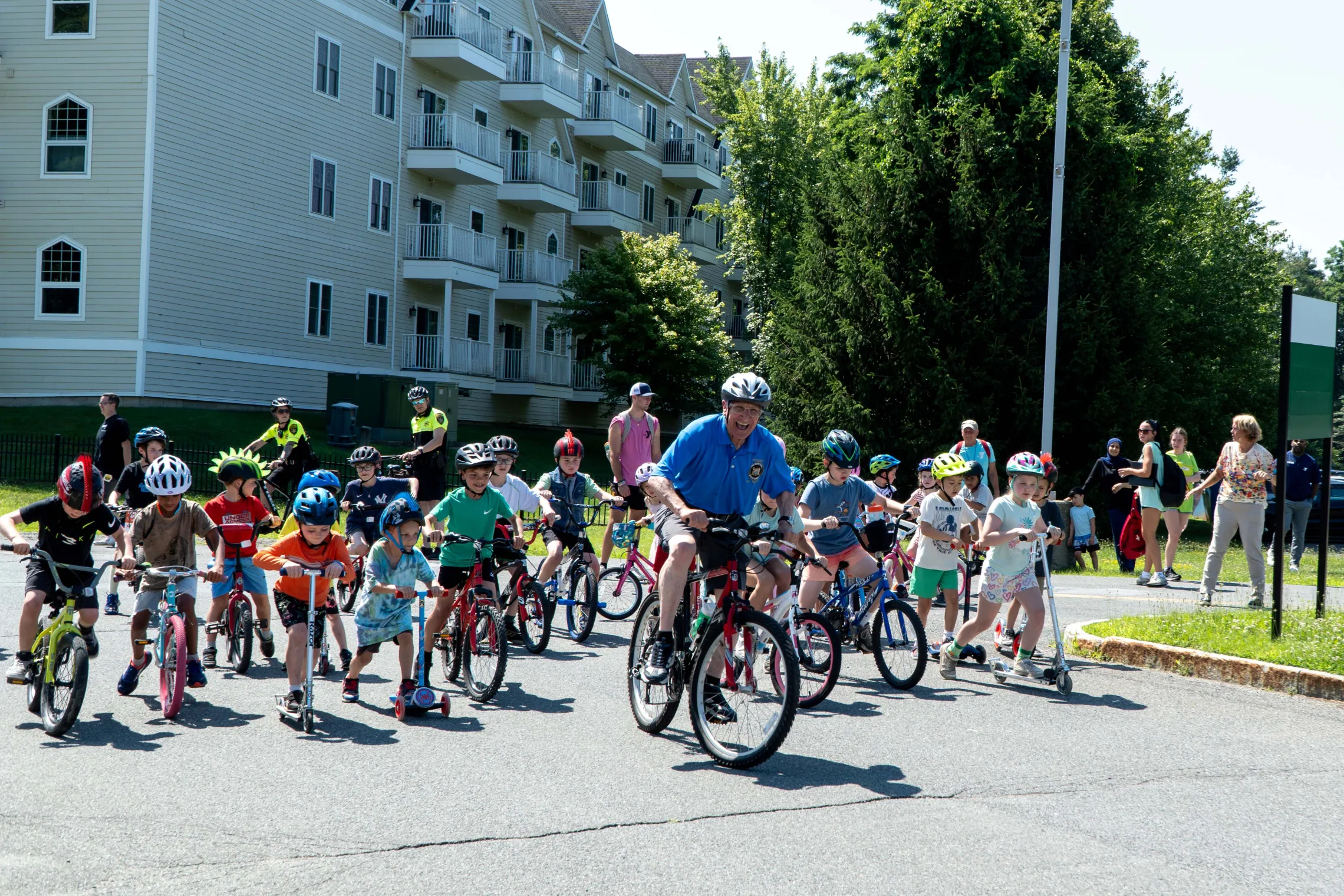 Large group of children ride bikes behind Senator Tedisco