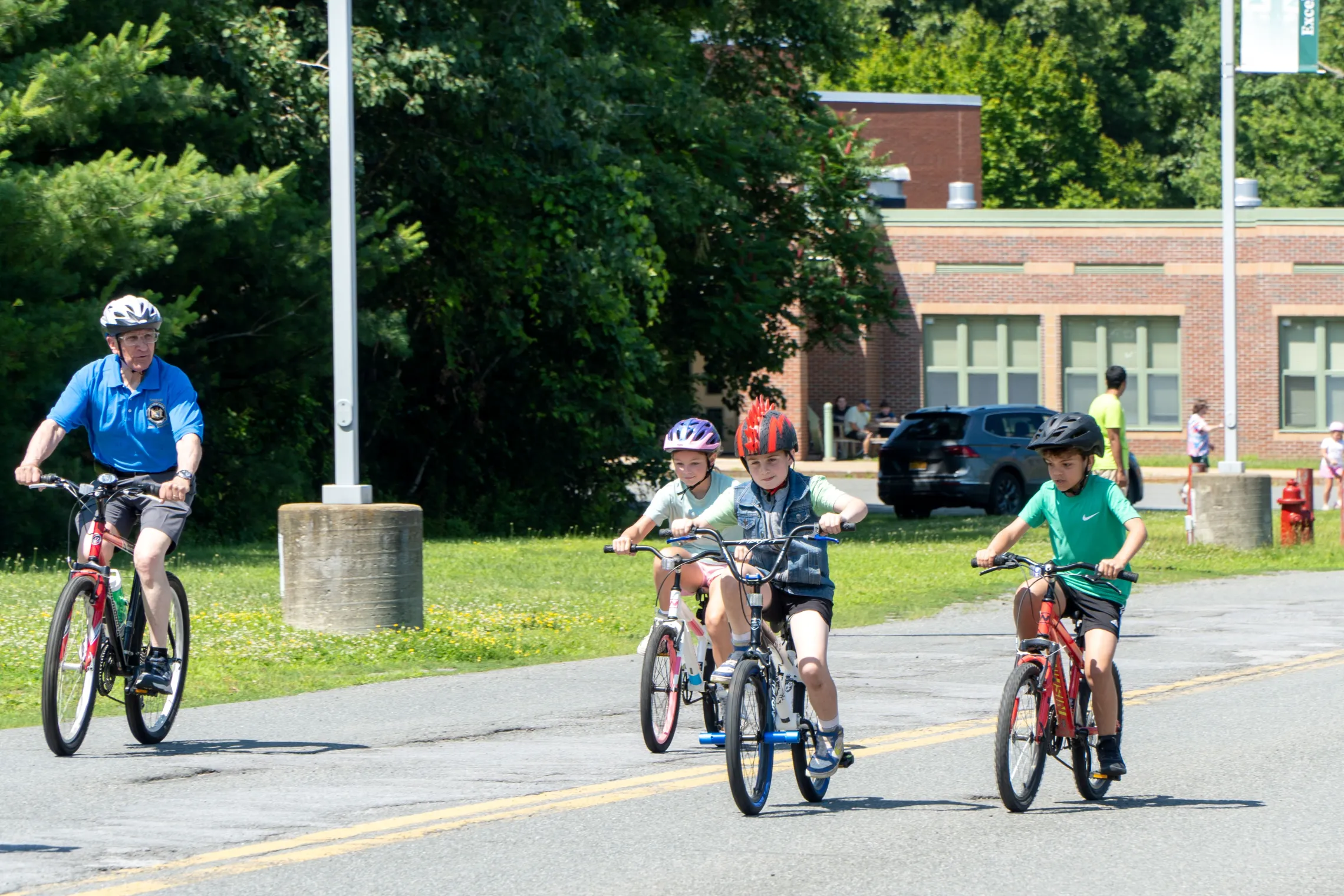 Children ride their bikes with Senator Tedisco