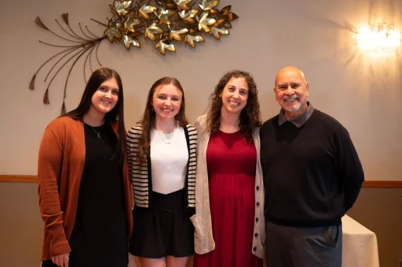 Group of four poses for a photo