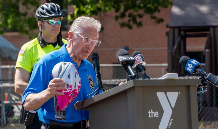 Senator Tedisco speaks at podium with helmet in hand