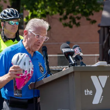 Senator Tedisco speaks at podium with helmet in hand