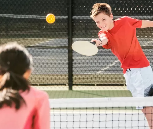 boy playing pickleball